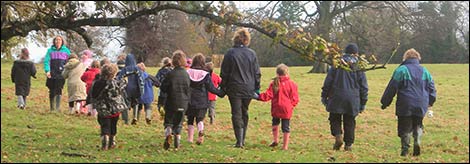 Children following storyteller Helen East