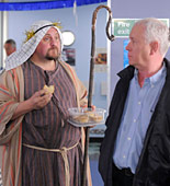 Big Mac (Charles Dale) tries to get Charlie (Derek Thompson) in the festive spirit