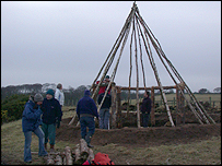 People building a reconstruction of the house