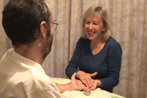 Peggy is giving John a hand massage to soothe the ravages of Motor Neurone Disease