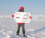john on artic ice with banner thaning sponsors