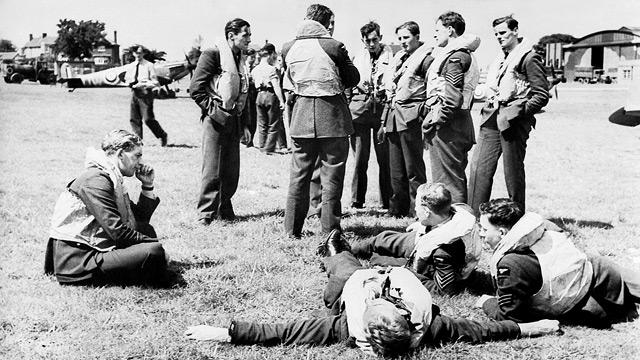 Some of 'the Few' relaxing between sorties at RAF Hawkinge in Kent, July 1940. Each man wears his life-jacket to save time when the call to scramble comes. 