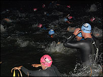 Athletes entered the water before dawn for the 2.4 mile swim in Sherborne Castle Lake.