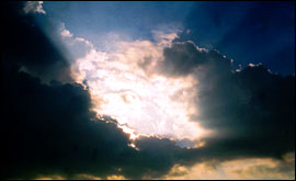 The sun appearing through  Cumulus clouds