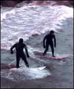 Surfers on the Severn Bore