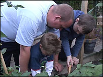 Father gardening with children
