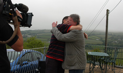 Ray stands to greet Simon
