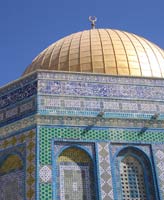 Gold dome and ornate blue and white pillared facade of Jerusalem's Dome of the Rock mosque