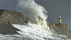 Big wave hitting a harbour wall