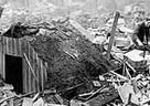 Photograph of an Anderson shelter intact after taking the full force of a bomb