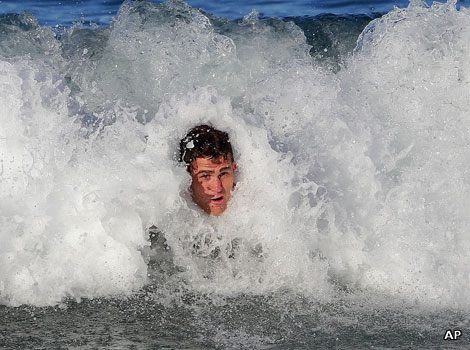 Australian rugby player James Horwill bodysurfs