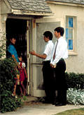 Two Mormons speak with a householder