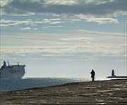 Neil Oliver walking along the Great South Wall