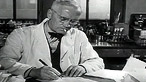 Black and white image of NHS doctor smoking a cigarette