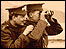 Two soldiers looking through binoculars