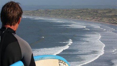 Steve Beach checking the surf at Rhossilli. Image by Claire Beach