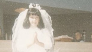 A young Liz Carr in her Holy Communion dress