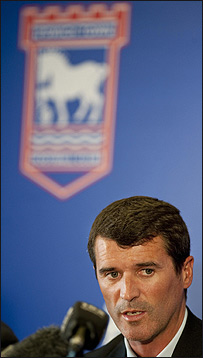 Roy Keane in front of the Ipswich Town Football Club badge