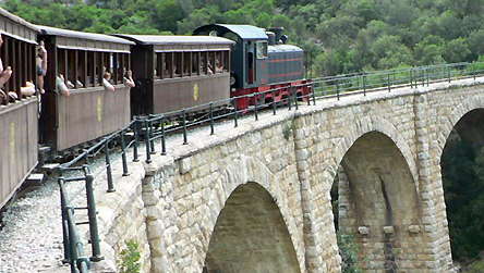 Narrow gauge train and railway Pelion Greece© BBC. Exactly a century ago the little train of Pelion started. The 'Volos - Milies' line was designed by Evaristo de Kiriko (father of the famous artist). Today many years after the closure of the line, the train has started functioning again. The journey is fascinating passing through green valleys, gorges, small tunnels and crossing arched bridges. It operates on the weekends travelling from Milies to Lehonia.