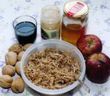 Bowl of charoset paste with ingredients: walnuts, wine, cinnamon, honey and apples