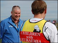 Runner and official at the finish 