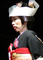 Japanese woman in ceremonial kimono, headdress and jewellery