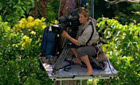 Justine Evans filming in the forest canopy