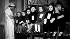 Very young evacuees prepare to travel, circa 1940. The experience was not always the exciting and jolly one that contemporary propaganda portrayed. 