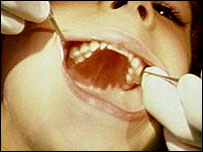 A dentist examines a patients teeth
