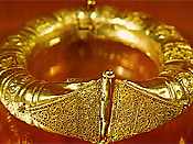 Intricately-carved circular gold bracelet