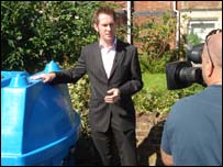BBC reporter Steve Knibbs filming at a bowser