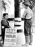 Photograph showing news-stand headlining the outbreak of World War Two
