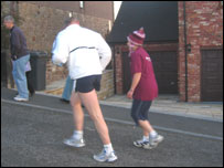Janine running up the Mow Cop hill with trainer