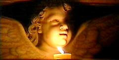 Statue of an angel holding a Paschal candle