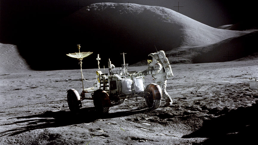 Astronaut James B. Irwin, Lunar Module pilot, works at the Lunar Roving Vehicle