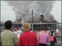 People watching Weston Pier on fire 