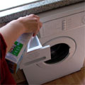 Washing powder being put into a domestic washing machine