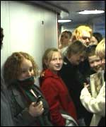 Passengers standing in the corridor