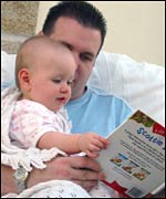 Dad reading to baby