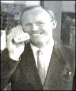 John Caudwell with an early mobile phone