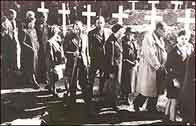 Photograph showing a group of German civilians forced to see the camp evidence for themselves