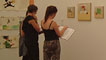 People taking in the displays at Y Lle Celf