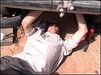 Lada man repairing car