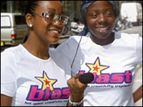 Two blast reporters holding a microphone