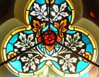 Stained glass window with three sections representing the Trinity