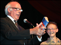 Graham Jolly onstage by a young audience member