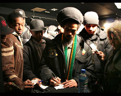 Damian signs autographs