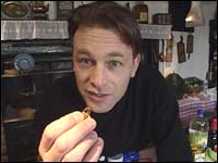 Chris Packham holding a vitamin capsule