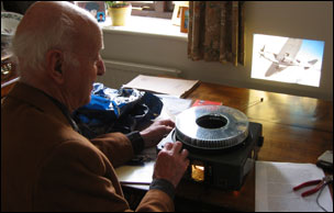 Peter Fahy at home with slide pictures