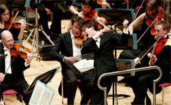 conductor in full flow, conducting his orchestra